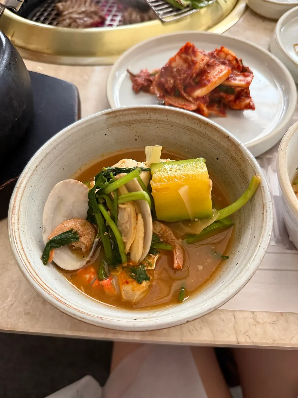 Close-up of the stew with large chunks of blue crab