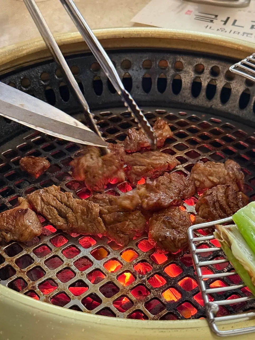 Seolhwa marinated ribs grilling over charcoal