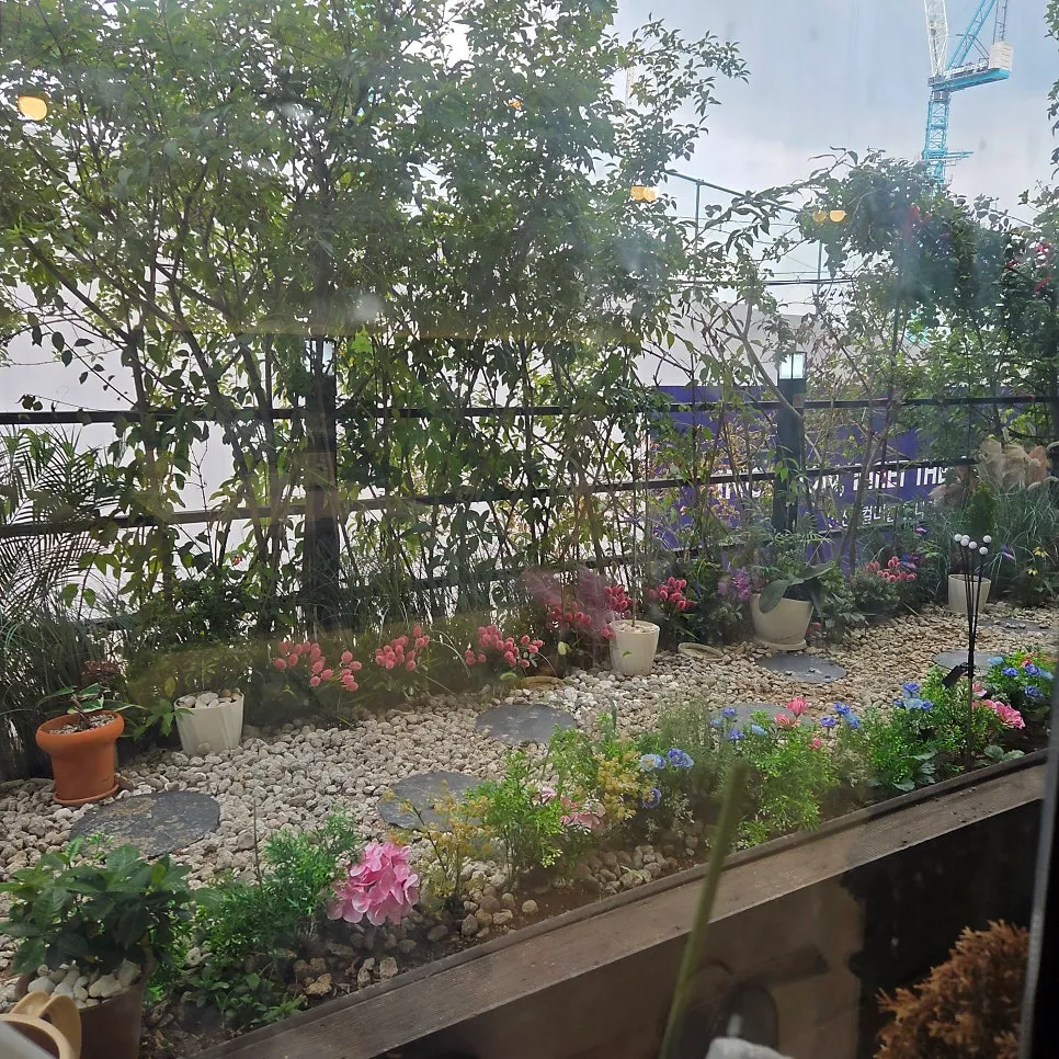 Small flower bed set up by the window seat