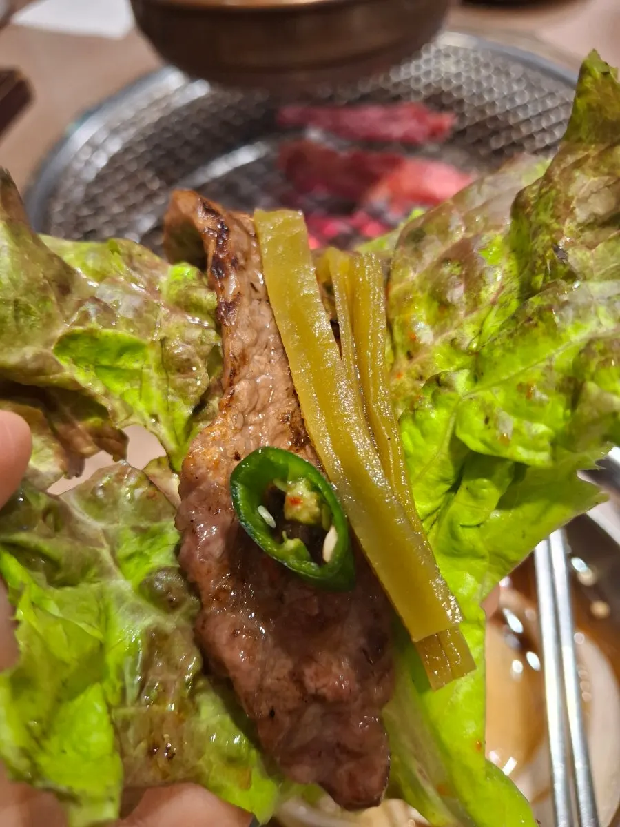 A bite of beef short rib meat topped with wasabi