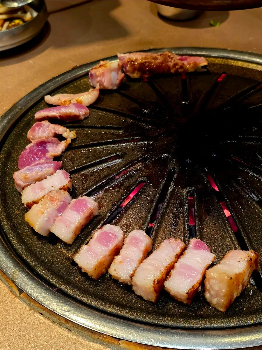 Handmade fresh pork galbi grilling on the pan