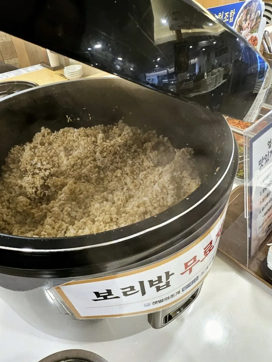 A bowl of barley rice with yeolmu kimchi and doenjang