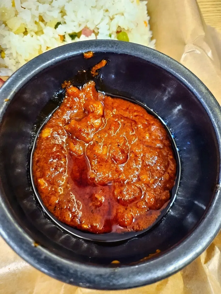 Sausage and flat pasta noodles mixed into the sauce