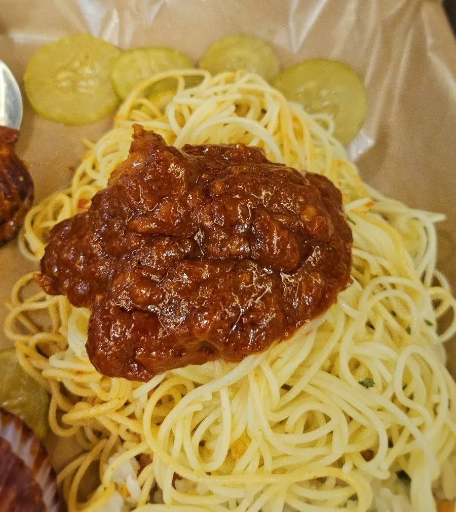 Flat pasta noodles lifted out of the pot