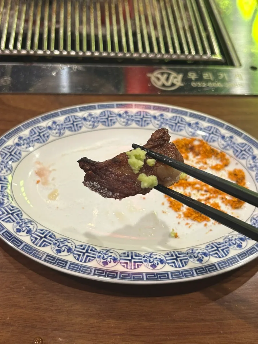 A piece of lamb rib with salt and wasabi