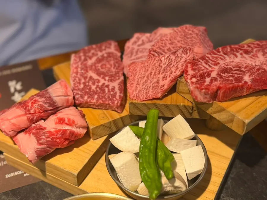 Side dishes including yukhoe minari salad and gungchae namul