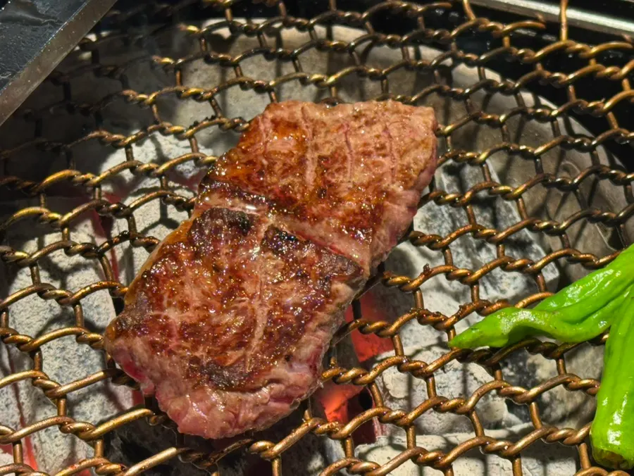 Heavily marbled sirloin cap on the grill