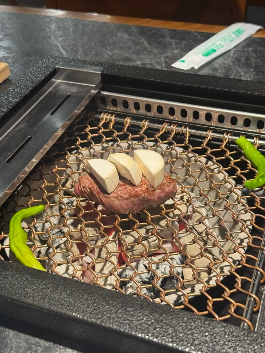 고기 위에 버섯을 올려 굽는 모습