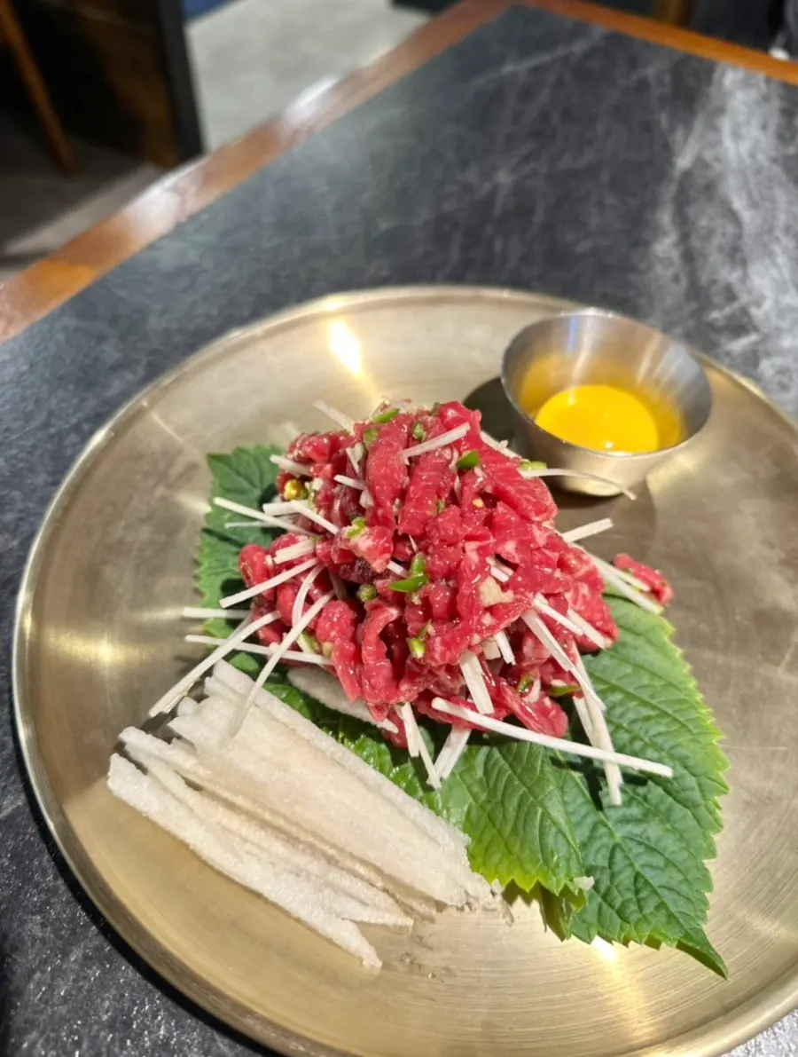 Hanwoo yukhoe served with egg yolk and pear