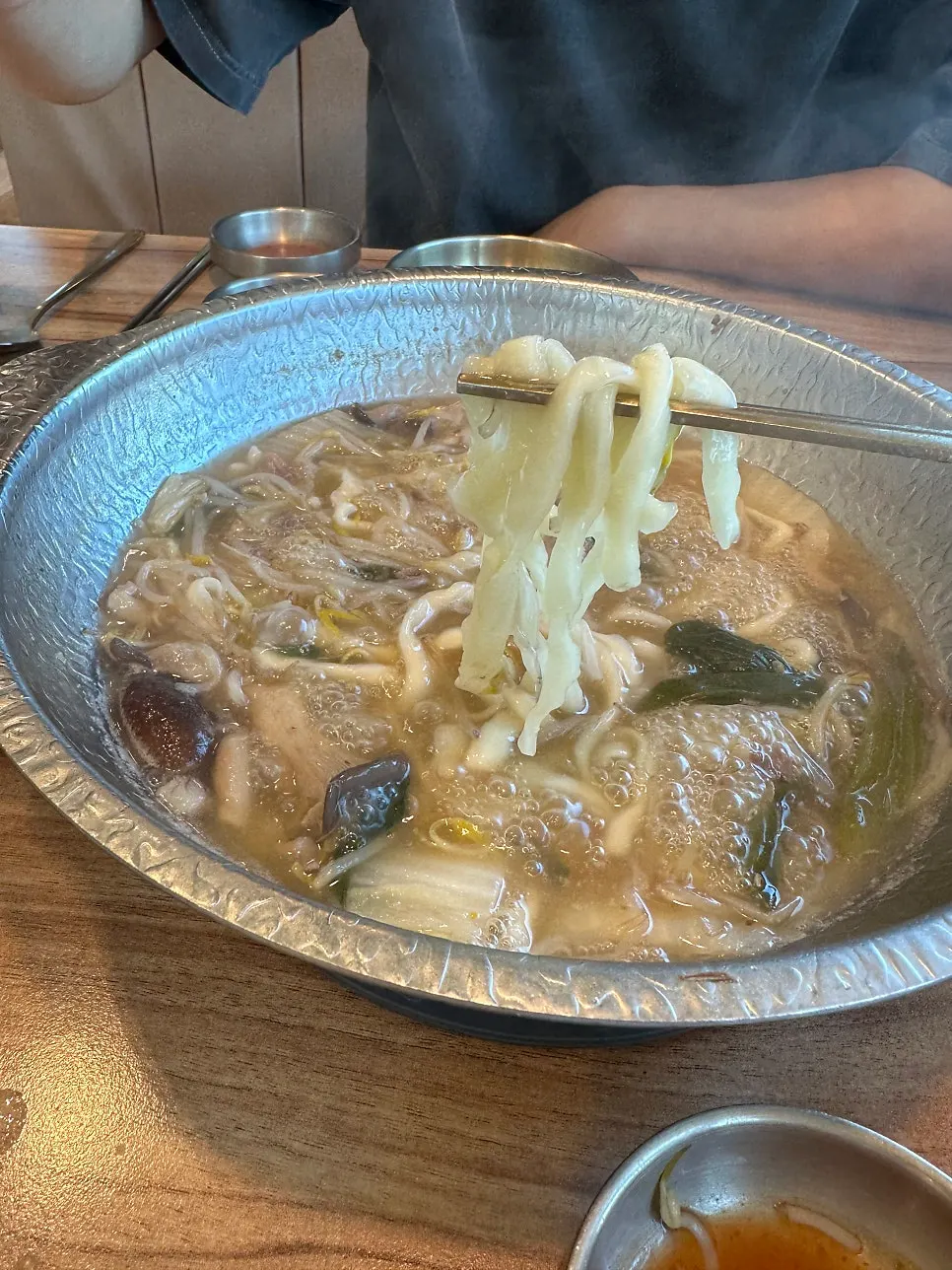 Thick kalguksu noodles added into the hot pot