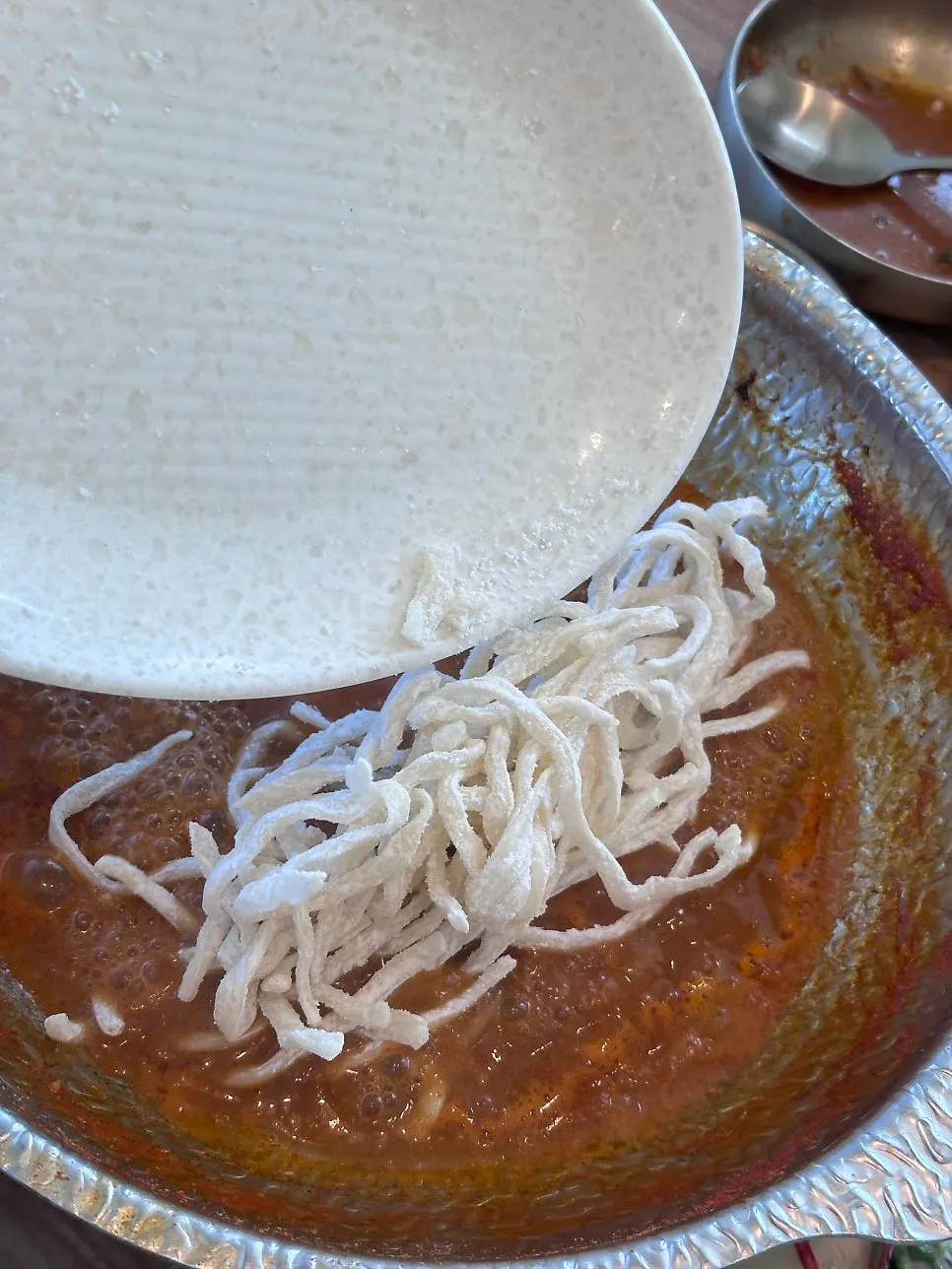 Table with both shabu shabu and pork minari pancake