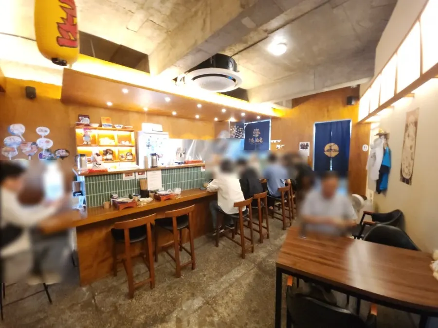 Counter seats and 4-person table inside Menya Tanuki