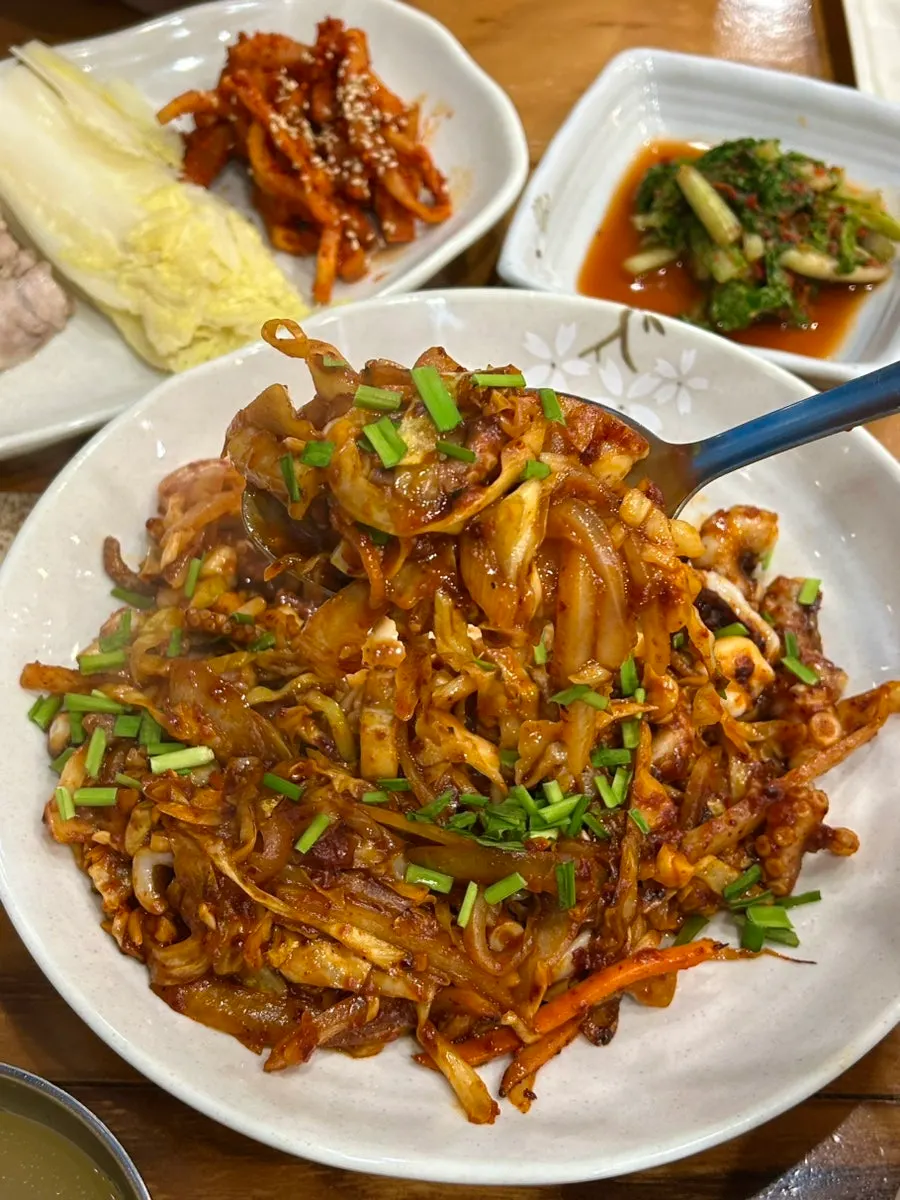 수육 한 점을 집어 든 모습