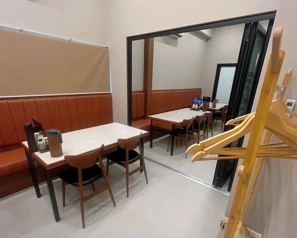 Widely spaced hall tables and entrance to the group room