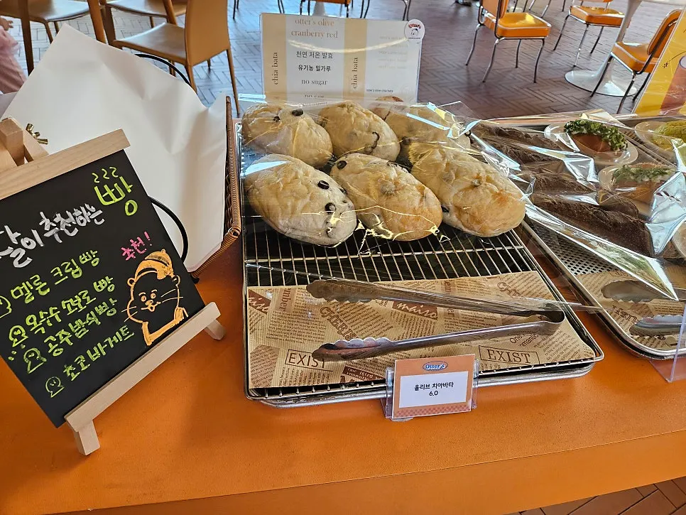 Cream doughnuts on the bakery display shelf at Otters