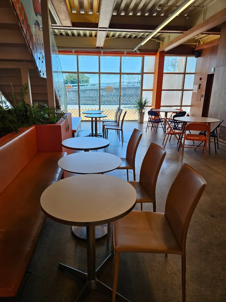 First floor seating at Otters with picture windows and high ceilings