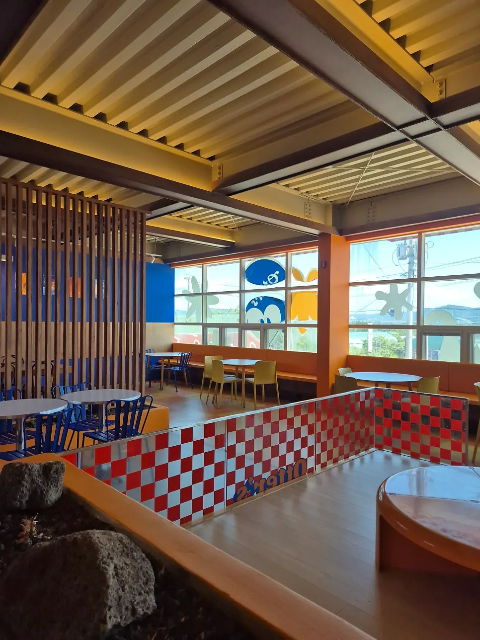 Second floor floor-seating area with donut-shaped tables at Otters