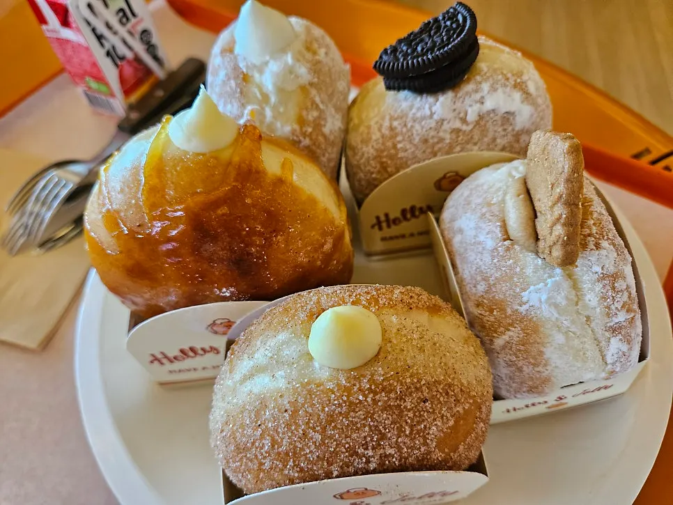 Five Otters doughnuts and a drink set on the table