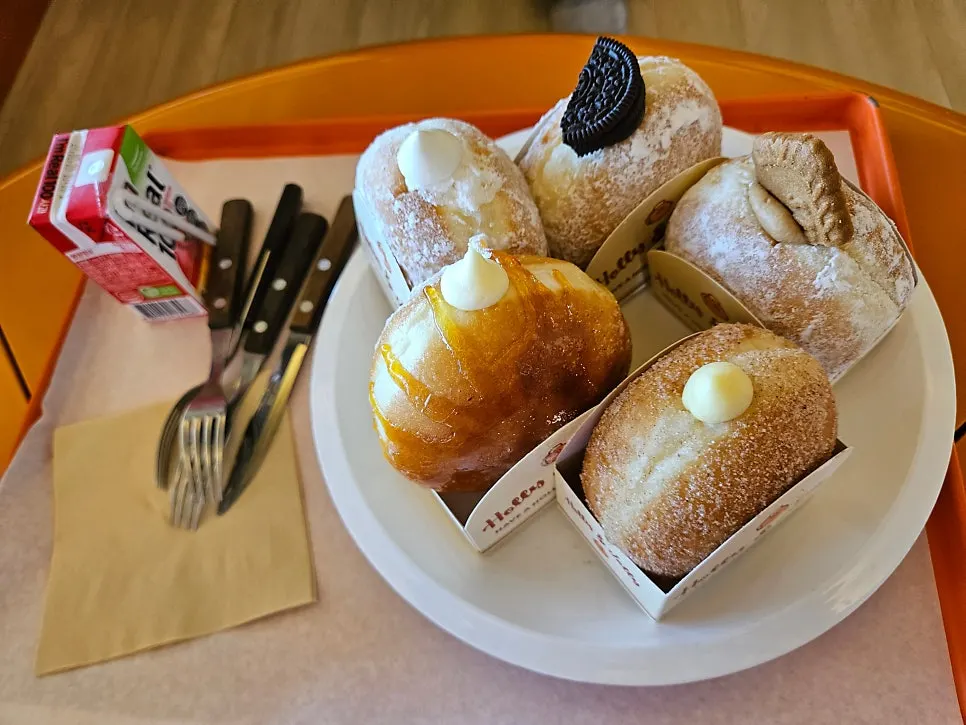 Five kinds of Otters cream doughnuts lined up on the table