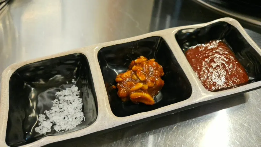 Salt, meat sauce, and a spread of side dishes