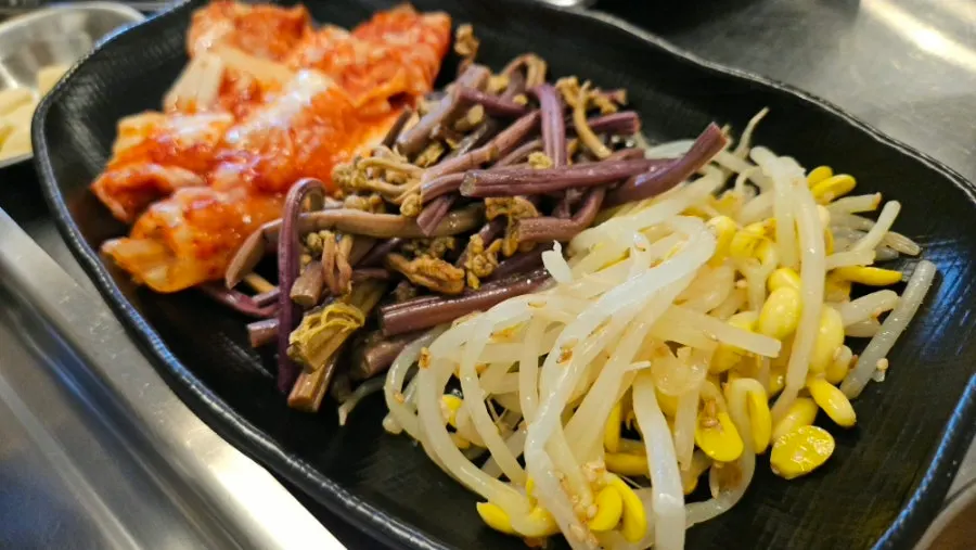 Bean sprouts, bracken fern, and kimchi cooked on the grill