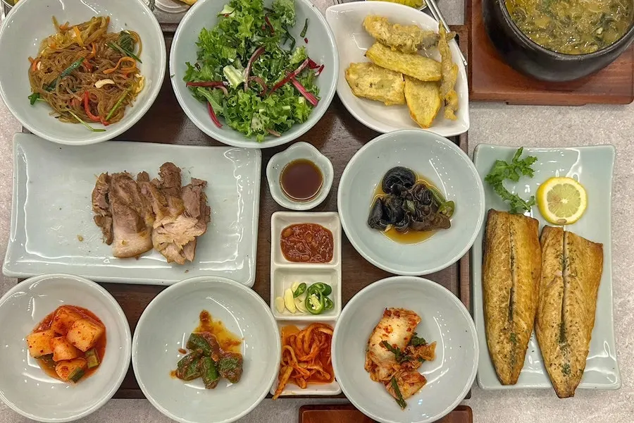 Set menu partway through eating, with boiled pork and fried items eaten