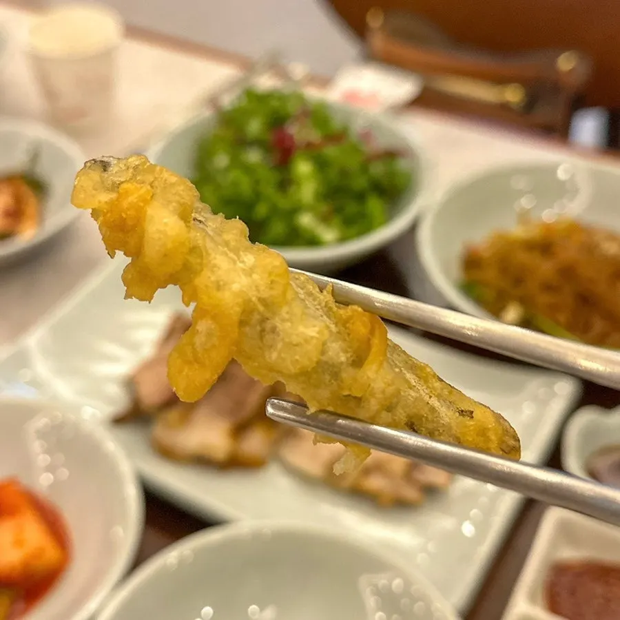 Fried loach, fried sweet potato, japchae, and other side dishes