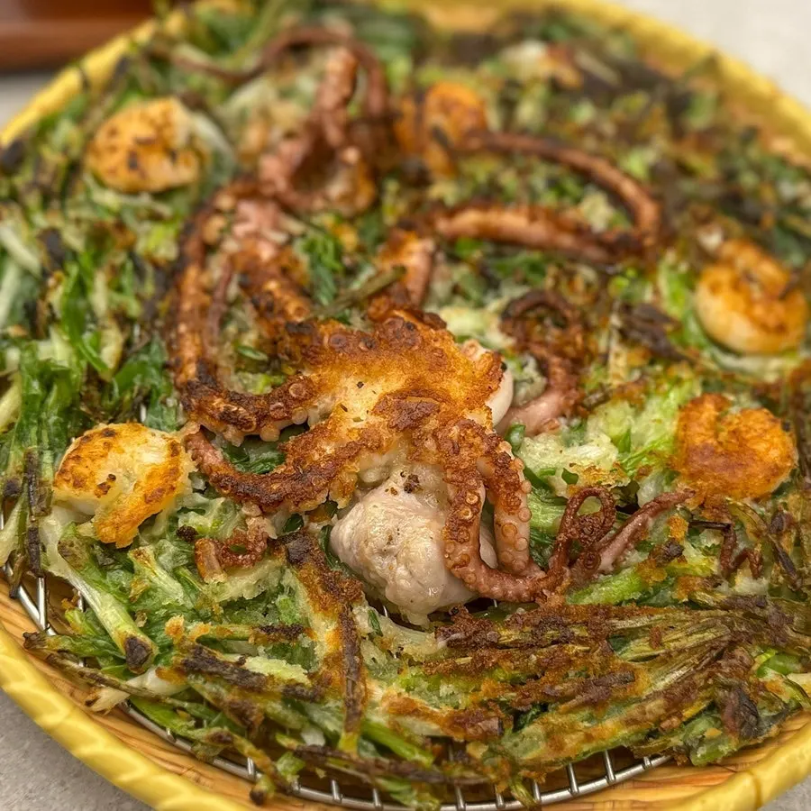 Seafood pancake topped with a whole octopus