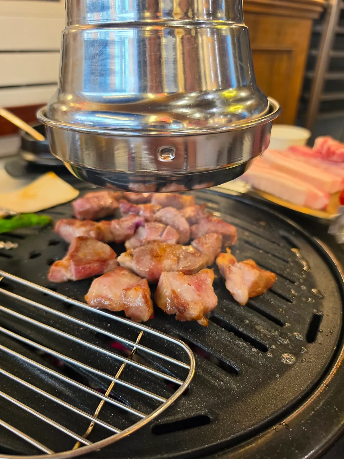 Meat turning golden brown on the charcoal grill