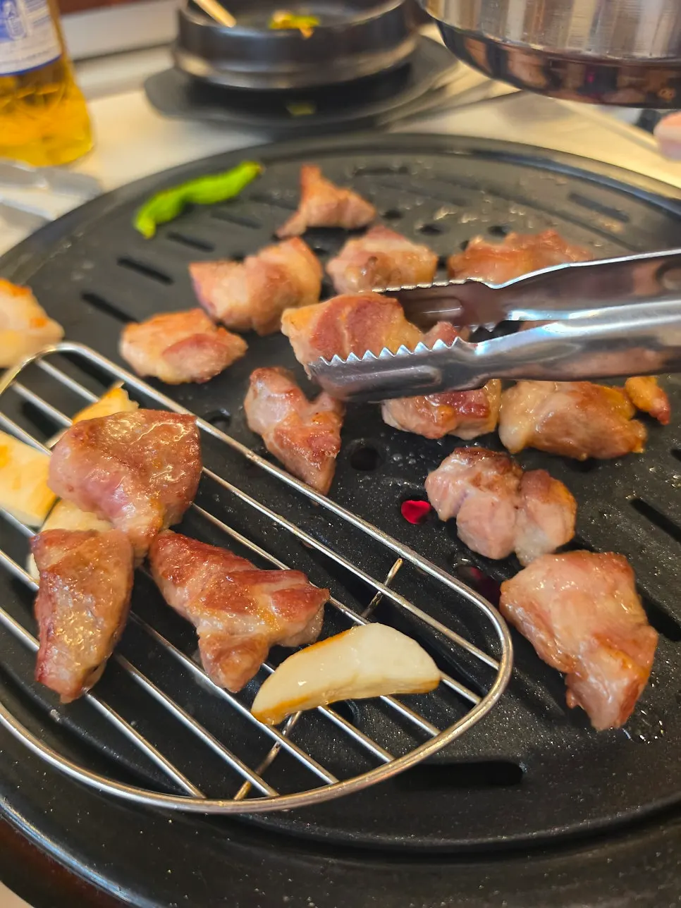 Grilled meat moved to the ledge on the side of the grill plate