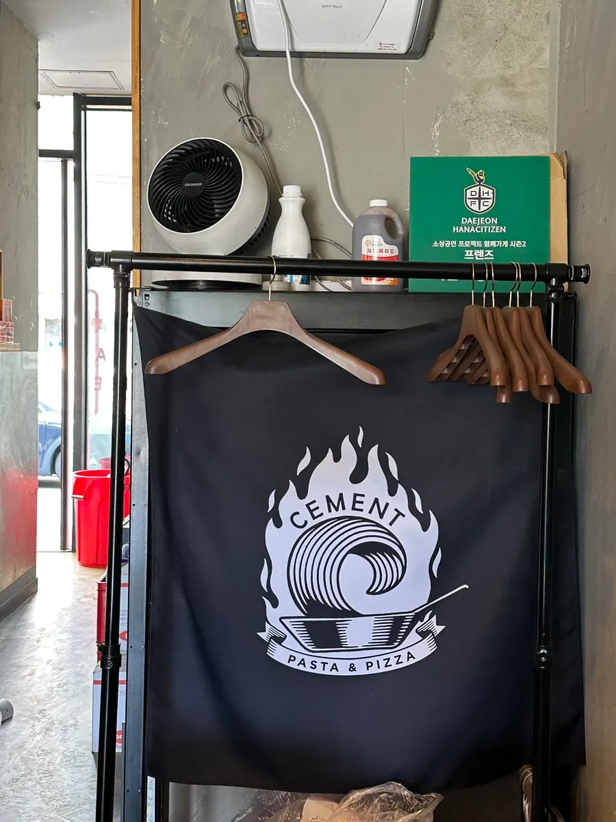 Wall with coat rack and logo at Ciment Chungnam National University branch