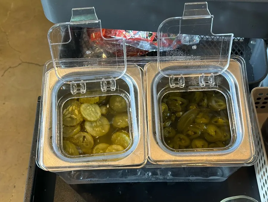 Pickles and jalapeños ready at the self-serve bar