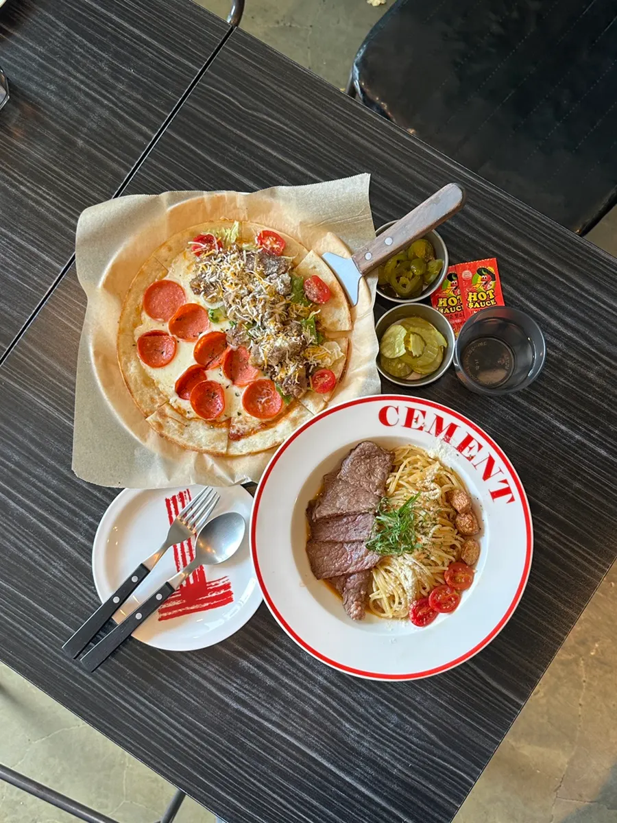 Table spread with pasta and half-and-half pizza