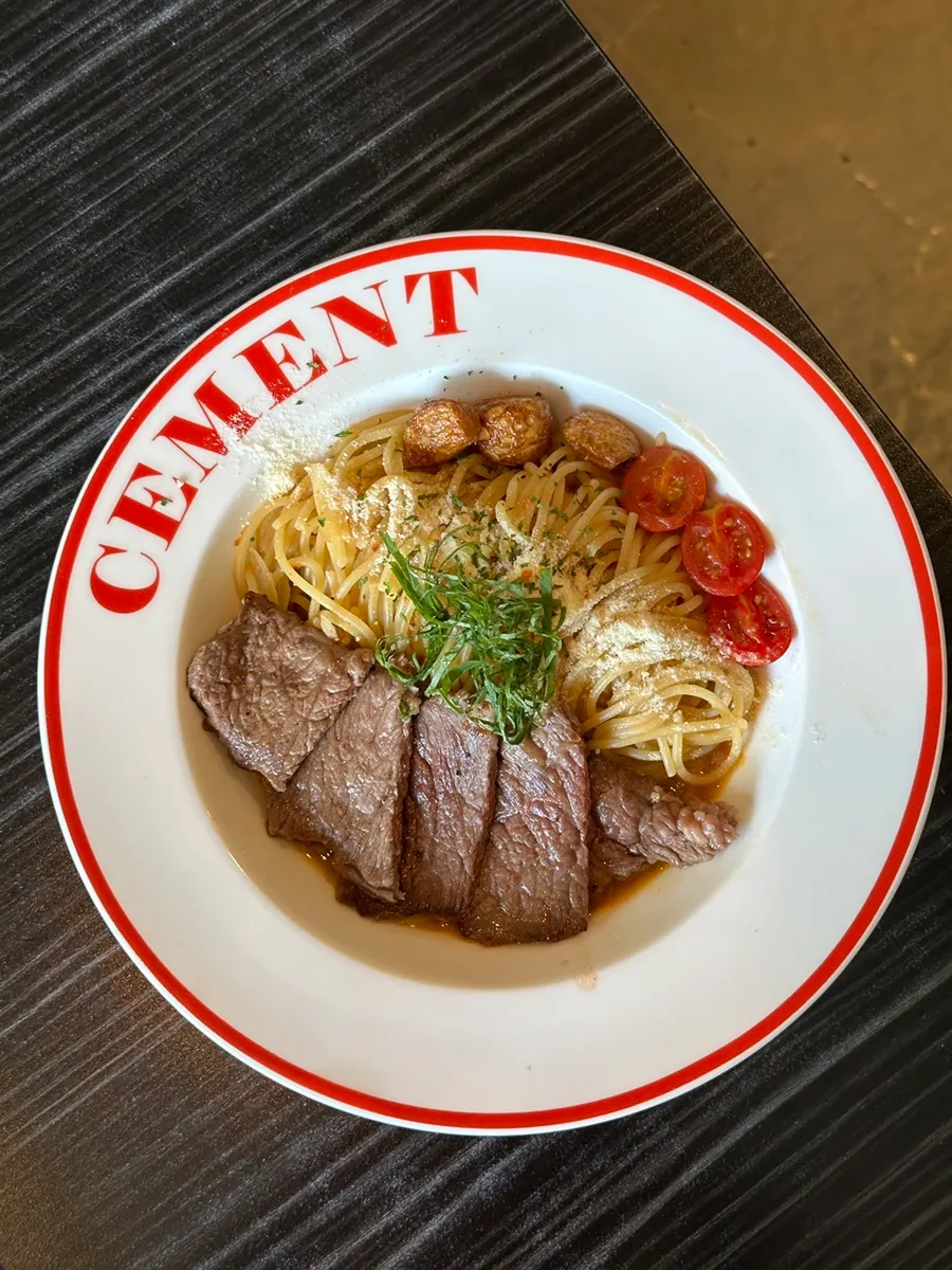 A plate of premium striploin garlic oil pasta