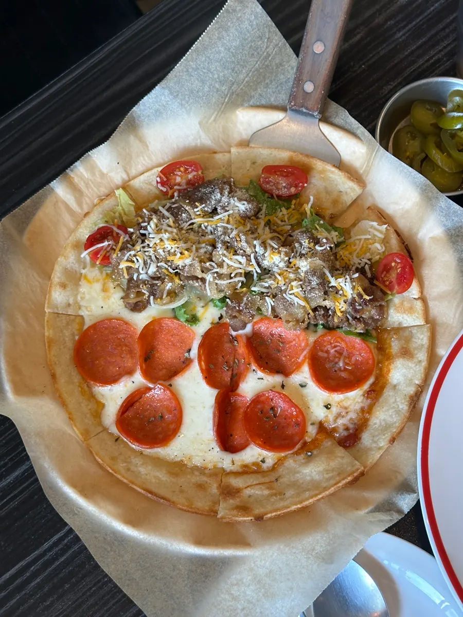 Cross-section of pizza showing dough, cheese, and toppings