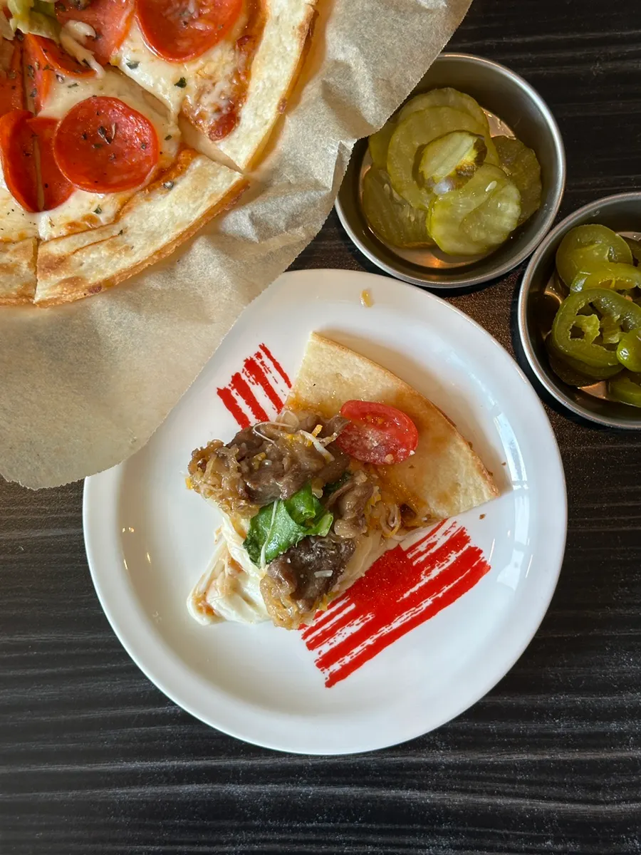 A slice of pizza portioned onto a small plate