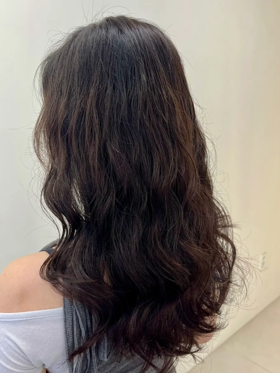 Long hair style after the layered perm treatment