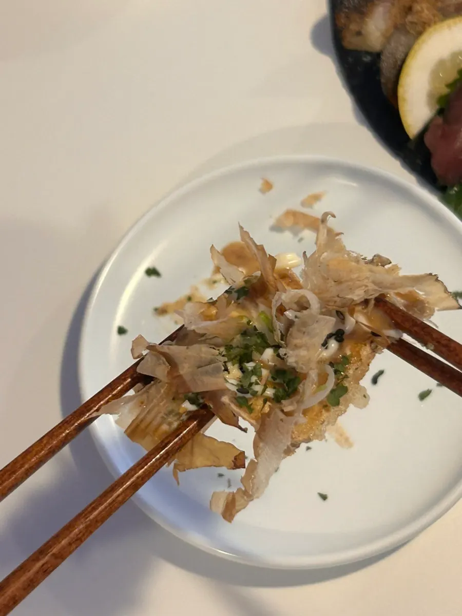 Complimentary fried tofu topped with bonito flakes