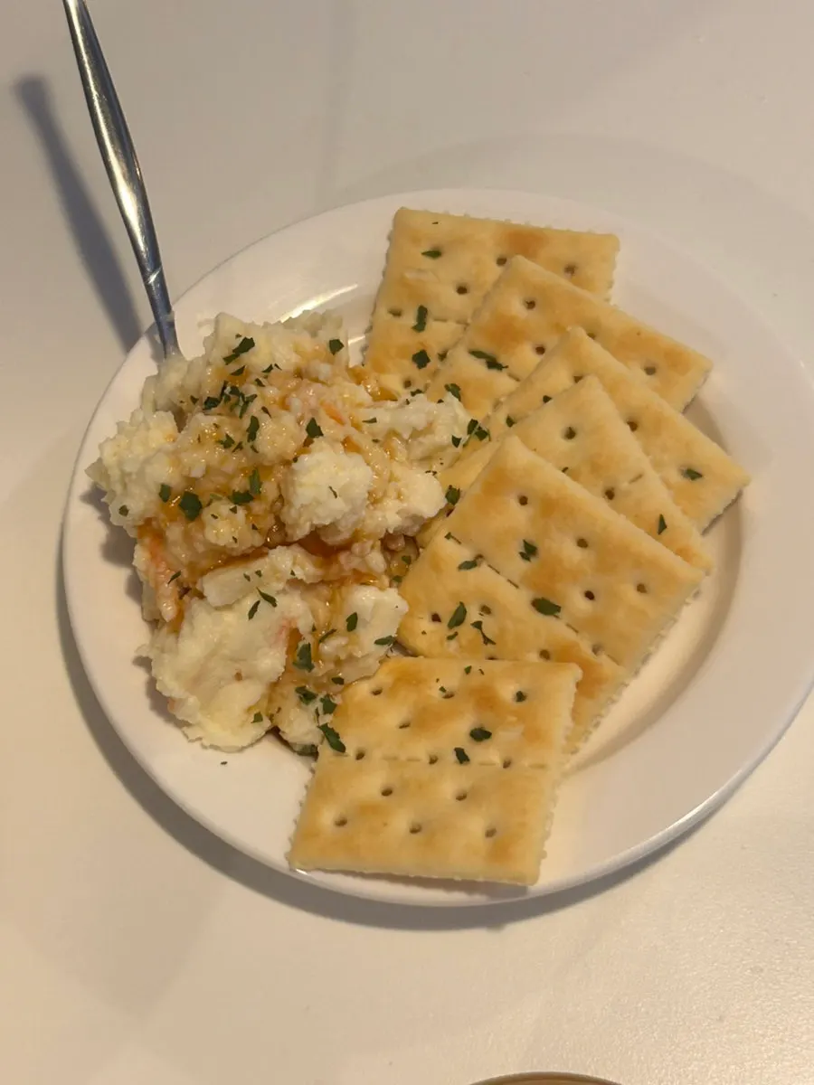 Potato salad piled on a cracker