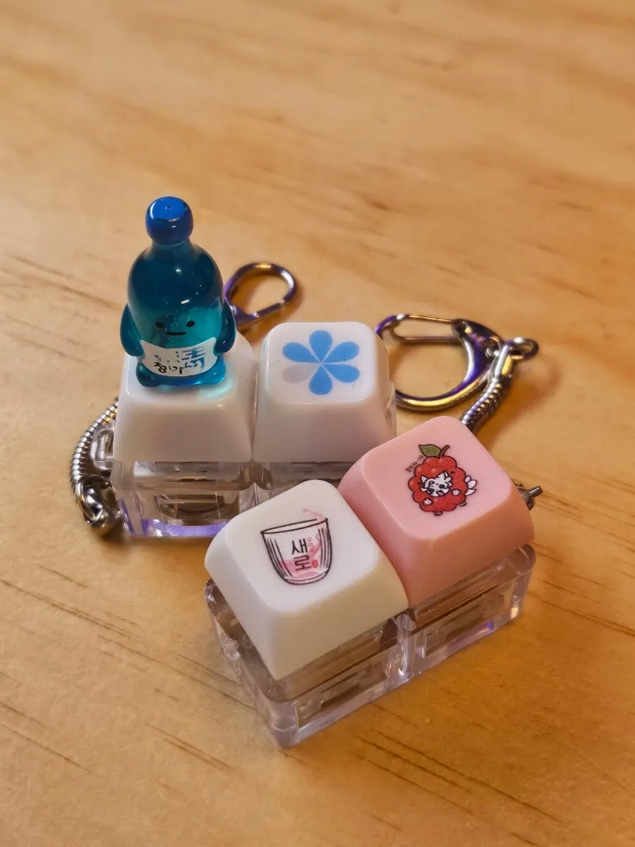 A soju-bottle keycap placed beside the table