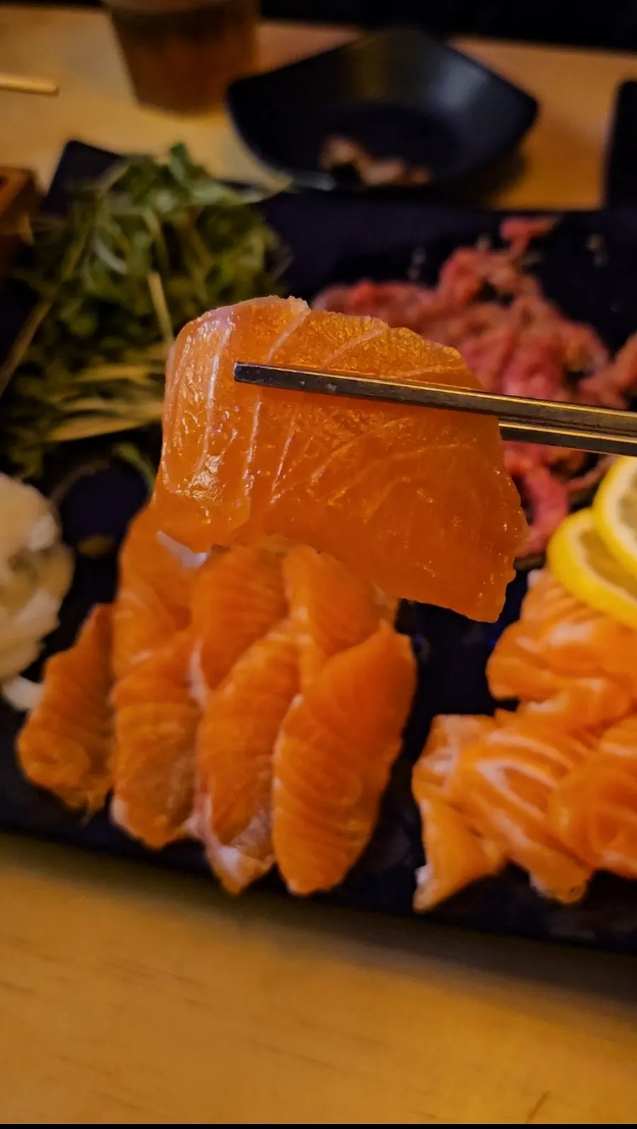 A generous plate of raw salmon slices