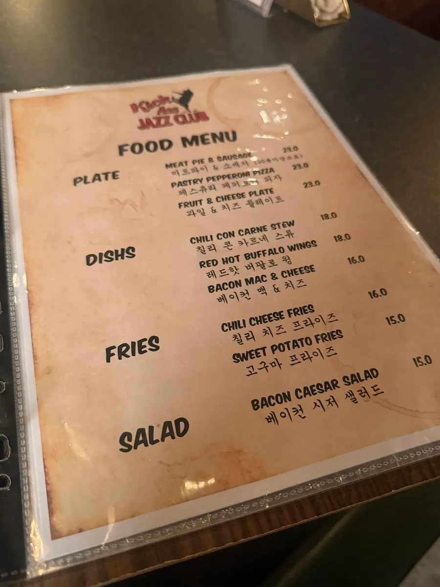 Sign explaining the cover charge and order requirements for show nights