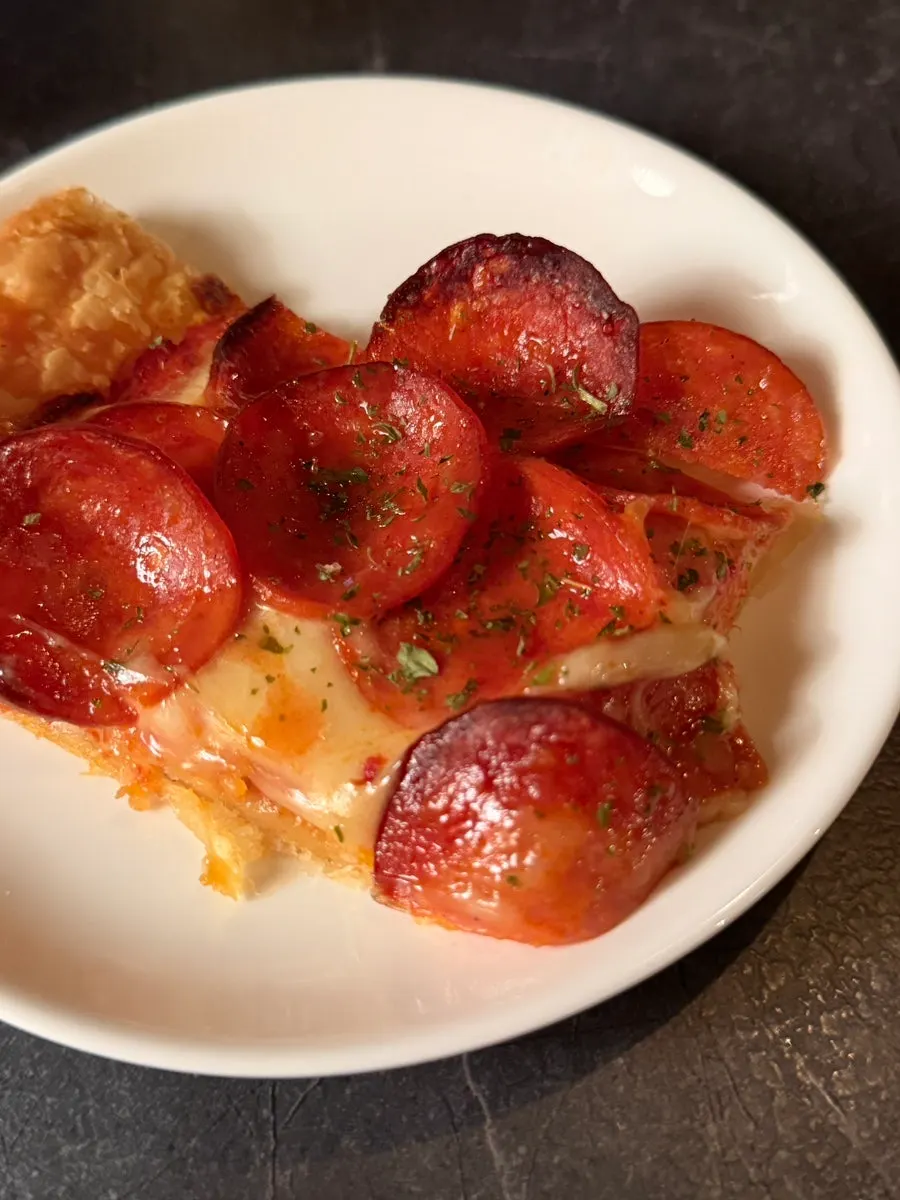 A whole pastry pepperoni pizza