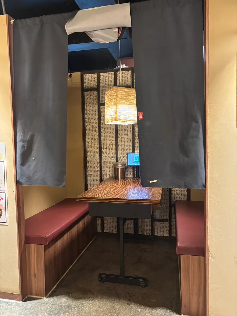 Seating with curtain dividers at Saechamjip