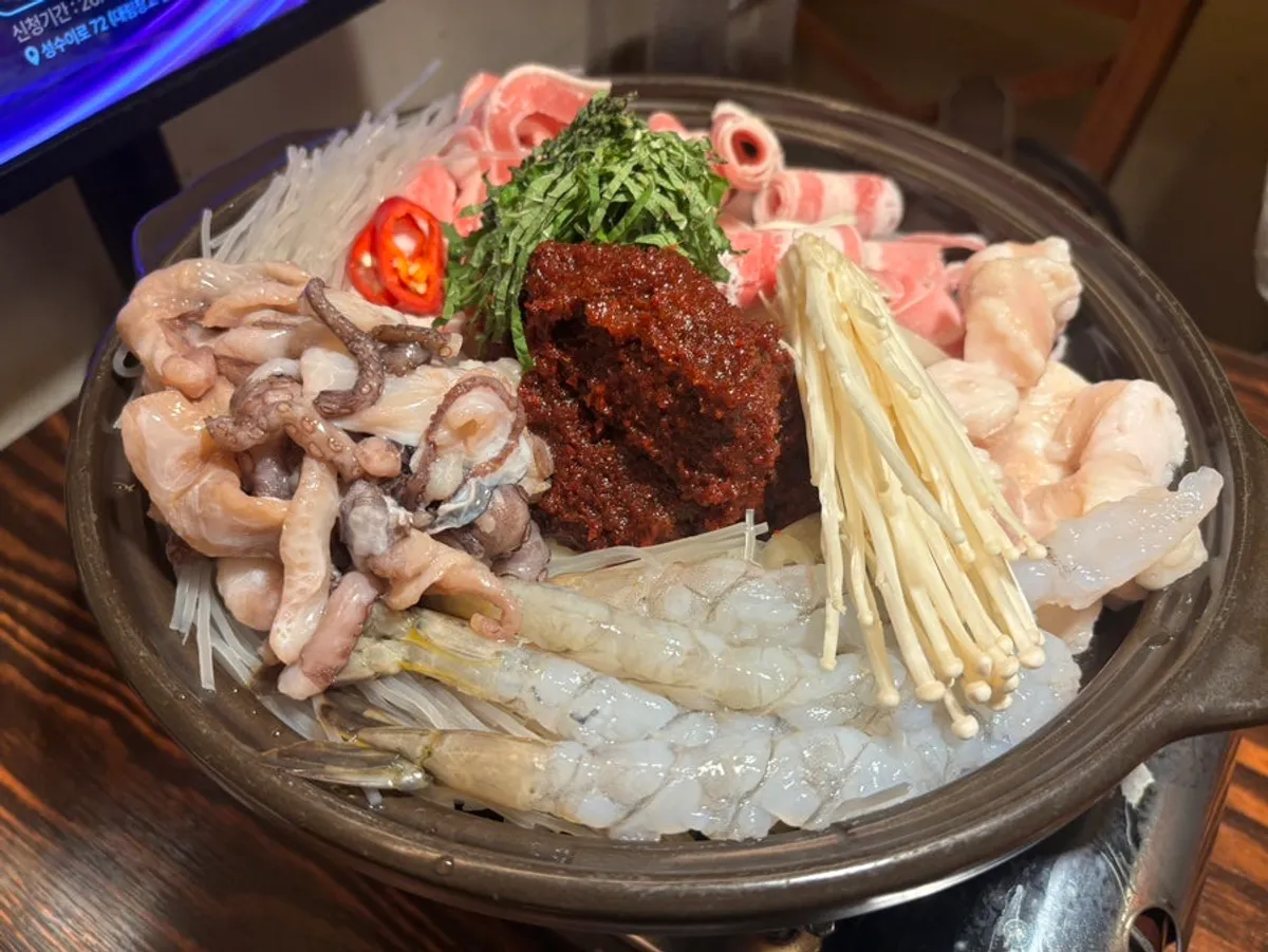 Strawberry smoothie makgeolli served in a stone bowl