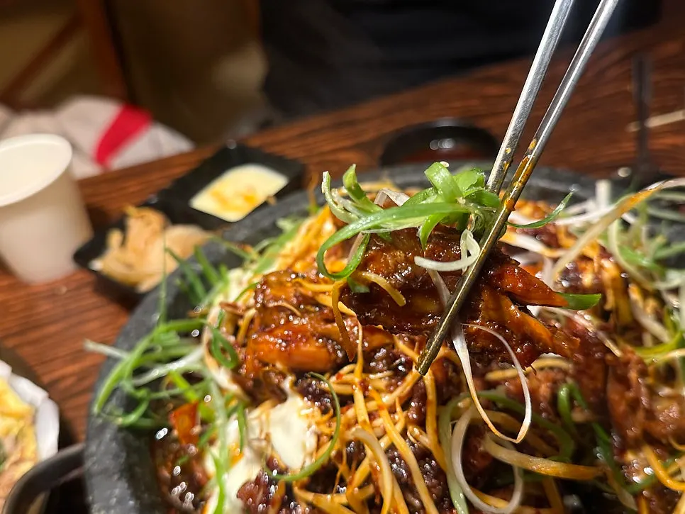Stone plate bone grill with scallions and bean sprouts