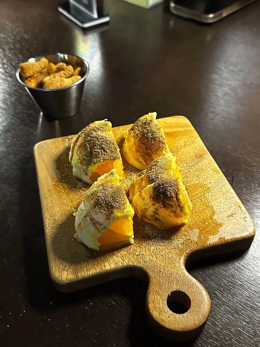 Signature Woowoo cocktail with a snack