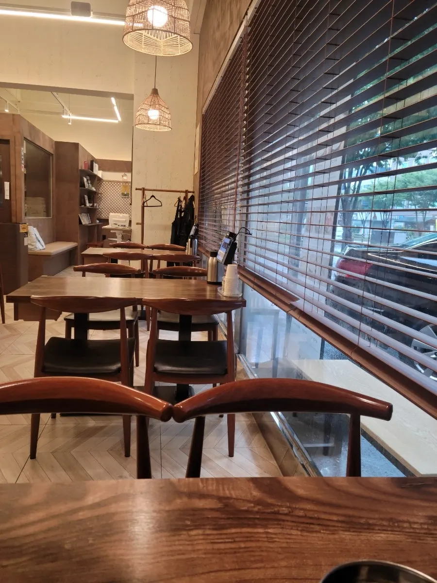 Spacious interior of Sosa Myeonok with wood-tone decor