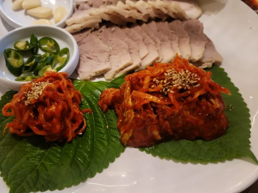 Boiled pork served with garlic, chili, and doenjang