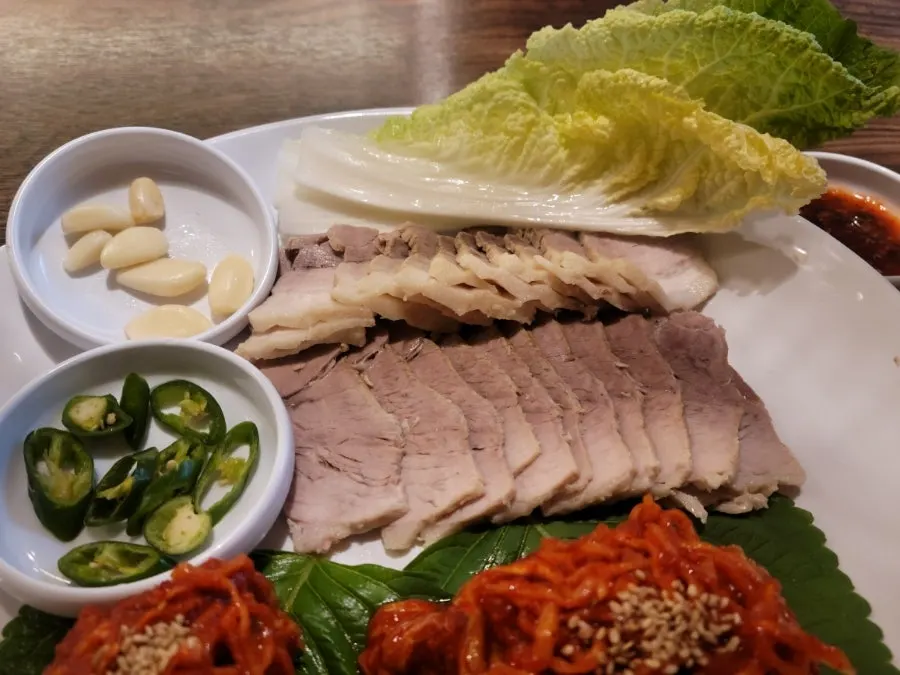 Tender boiled pork with napa cabbage kimchi and mu kimchi